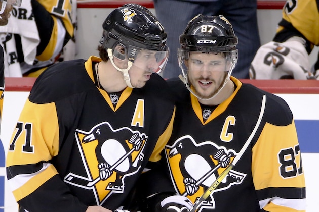 Pittsburgh Penguins' Sidney Crosby (87) and Evgeni Malkin talk as they return to the ice after a stop in play during the third period of Game 6 of the NHL hockey Stanley Cup Eastern Conference semifinals against the Washington Capitals], Tuesday, May 10, 2016 in Pittsburgh. (AP Photo/Gene J. Puskar)