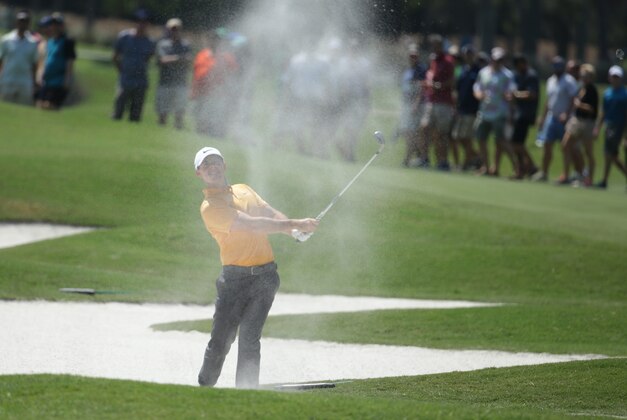 Rory McIlroy of Northern Ireland, hits onto the fifth green during the first round of The Players Championship golf tournament Thursday, May 12, 2016, in Ponte Vedra Beach, Fla. (AP Photo/Lynne Sladky)