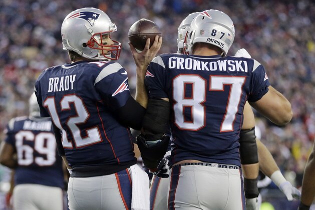 New England Patriots quarterback Tom Brady (12) celebrates his touchdown pass to tight end Rob Gronkowski (87) in the first half of an NFL divisional playoff football game against the Kansas City Chiefs, Saturday, Jan. 16, 2016, in Foxborough, Mass.(AP Photo/Steven Senne)