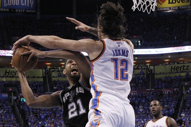 San Antonio Spurs center Tim Duncan (21) is fouled by Oklahoma City Thunder center Steven Adams (12) as he shoots in the second quarter of Game 6 of a second-round NBA basketball playoff series in Oklahoma City, Thursday, May 12, 2016. (AP Photo/Alonzo Adams)