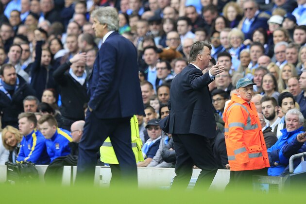 United’s manager Louis van Gaal, right, and Manchester City's manager Manuel Pellegrini, left, stand beside the pitch during the English Premier League soccer match between Manchester City and Manchester United at the Etihad stadium in Manchester, Sunday, March 20, 2016.(AP Photo/Jon Super)