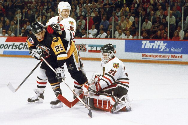 The Pittsburgh Penguins'  Kevin Stevens takes a shot on goal against Chicago Blackhawks goalie Dominik Hasek as the Backhawks Steve Smith looks on during the first period on Monday, June 2, 1992 in Chicago.   The Penguins beat the Blackhawks 6-5 to win their second consecutive Stanley Cup. (AP Photo/Fred Jewell)