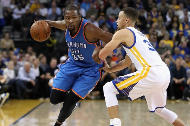 OAKLAND, CA - MARCH 03:  Kevin Durant #35 of the Oklahoma City Thunder tries to dribble past Stephen Curry #30 of the Golden State Warriors at ORACLE Arena on March 3, 2016 in Oakland, California.  NOTE TO USER: User expressly acknowledges and agrees that, by downloading and or using this photograph, User is consenting to the terms and conditions of the Getty Images License Agreement.  (Photo by Ezra Shaw/Getty Images)