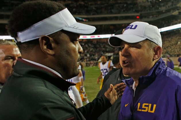 COLLEGE STATION, TX - NOVEMBER 27:  Texas A&M Aggies head coach Kevin Sumlin (L) greets head coach Les Miles of the LSU Tigers on the field after the Tigers won 23-17 at Kyle Field on November 27, 2014 in College Station, Texas.  (Photo by Scott Halleran/Getty Images)