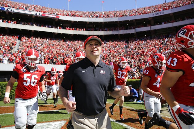 New Georgia head coach Kirby Smart runs into a packed Sanford Stadium with his players for the their spring  intrasquad NCAA college football game Saturday, April 16, 2016, in Athens, Ga.  (AP Photo/John Bazemore)