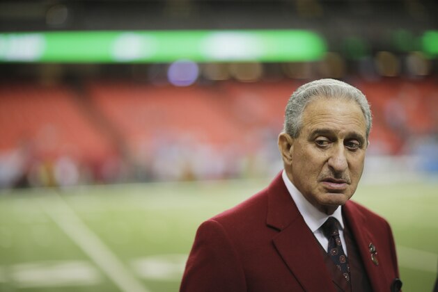Atlanta Falcons owner Arthur Blank walks on the turf before the first half of an NFL football game between the Atlanta Falcons and the Carolina Panthers, Sunday, Dec. 27, 2015, in Atlanta. (AP Photo/David Goldman)