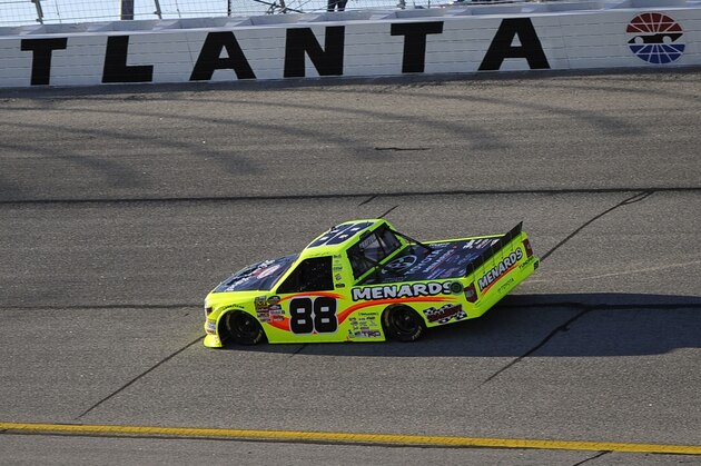 Matt Crafton rounds turn one while leading a NASCAR Trucks Series auto race at Atlanta Motor Speedway Saturday, Feb. 27, 2016, in Hampton, Ga. (AP Photo/John Amis)