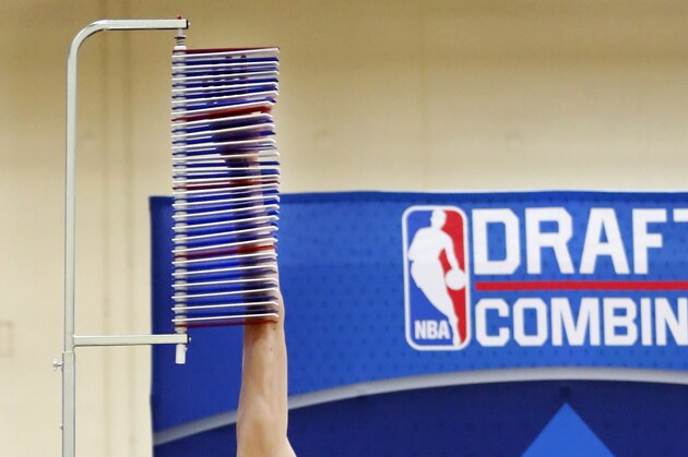 Zhou Qi, from China, reaches the 12-foot mark at the vertical leap station during the NBA draft basketball combine Thursday, May 12, 2016, in Chicago. (AP Photo/Charles Rex Arbogast)