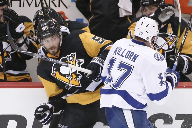 Pittsburgh Penguins' Kris Letang (58) and Tampa Bay Lightning's Alex Killorn (17) tangle along the boards during the third period of Game 1 of the NHL hockey Stanley Cup Eastern Conference finals Friday, May 13, 2016, in Pittsburgh. The Lightning won 3-1. (AP Photo/Gene J. Puskar)