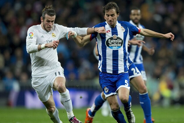 Real Madrid's Welsh forward Gareth Bale (L) vies with Deportivo La Coruna's defender Pedro Mosquera (R) during the Spanish league football match Real Madrid CF vs RC Deportivo de la Coruna at the Santiago Bernabeu stadium in Madrid on January 9, 2016.   AFP PHOTO / GONZALO ARROYO / AFP / GONZALO ARROYO        (Photo credit should read GONZALO ARROYO/AFP/Getty Images)