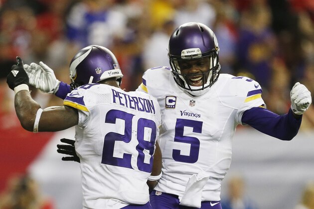 Minnesota Vikings running back Adrian Peterson (28) celebrates his touchdown with Minnesota Vikings quarterback Teddy Bridgewater (5) against the Atlanta Falcons during the second half of an NFL football game, Sunday, Nov. 29, 2015, in Atlanta. (AP Photo/Butch Dill)