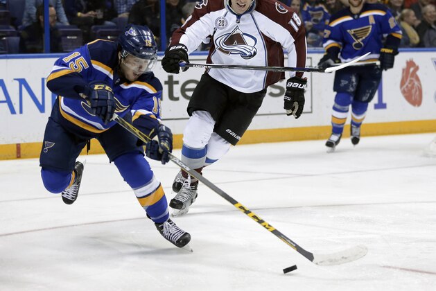 St. Louis Blues' Robby Fabbri, left, reaches for a loose puck as Colorado Avalanche's Shawn Matthias watches during the first period of an NHL hockey game Tuesday, March 29, 2016, in St. Louis. (AP Photo/Jeff Roberson)