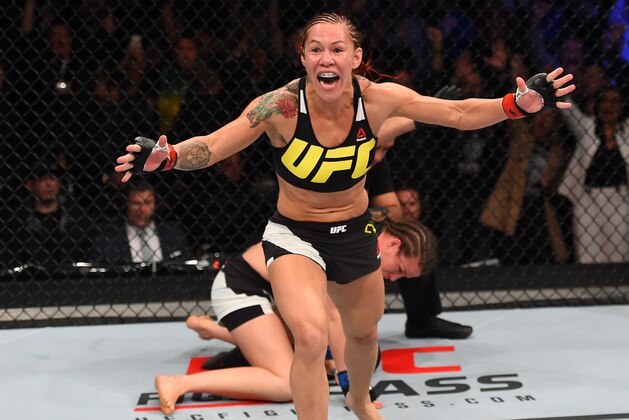 CURITIBA, BRAZIL - MAY 14:  (L-R) Cristiane 'Cyborg' Justino of Brazil celebrates after defeating Leslie Smith in their women's catchweight bout during the UFC 198 event at Arena da Baixada stadium on May 14, 2016 in Curitiba, Parana, Brazil.  (Photo by Josh Hedges/Zuffa LLC/Zuffa LLC via Getty Images)