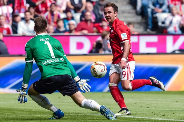 Bayern Munich's midfielder Mario Goetze (R) scores his sides second goal past Hanover's goalkeeper Ron-Robert Zieler during the German first division Bundesliga football match between FC Bayern Munich and Hannover 96 in Munich, southern Germany, on May 14, 2016. / AFP / GUENTER SCHIFFMANN / RESTRICTIONS: DURING MATCH TIME: DFL RULES TO LIMIT THE ONLINE USAGE TO 15 PICTURES PER MATCH AND FORBID IMAGE SEQUENCES TO SIMULATE VIDEO. == RESTRICTED TO EDITORIAL USE == FOR FURTHER QUERIES PLEASE CONTACT DFL DIRECTLY AT + 49 69 650050
        (Photo credit should read GUENTER SCHIFFMANN/AFP/Getty Images)