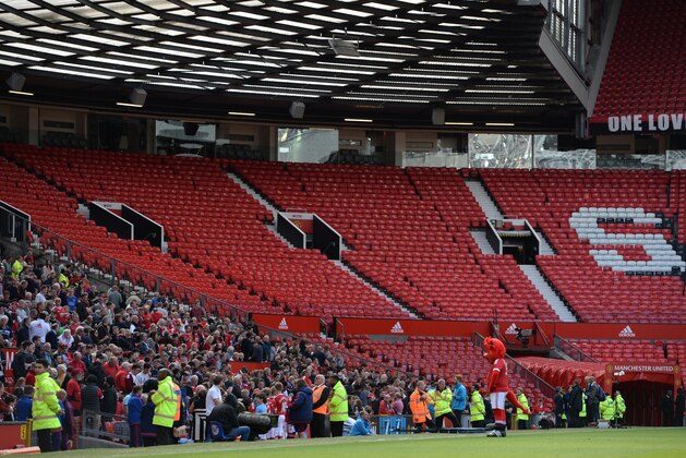 The Stretford End is pictured empty following the evacuation of both the Sir Alex Ferguson stand (unseen) and the Stretford stands ahead of the English Premier League football match between Manchester United and Bournemouth at Old Trafford in Manchester, north west England, on May 15, 2016. / AFP / OLI SCARFF / RESTRICTED TO EDITORIAL USE. No use with unauthorized audio, video, data, fixture lists, club/league logos or 'live' services. Online in-match use limited to 75 images, no video emulation. No use in betting, games or single club/league/player publications.  /         (Photo credit should read OLI SCARFF/AFP/Getty Images)