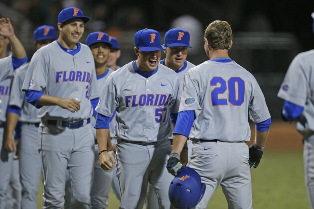 CORAL GABLES, FL - FEBRUARY 26: Teammates congratulate Peter Alonso #20 of the Florida Gators after he hit a two run home run against the Miami Hurricanes on February 26, 2016 at Alex Rodriguez Park at Mark Light Field in Coral Gables, Florida. Florida defeated Miami 5-0. (Photo by Joel Auerbach/Getty Images)
