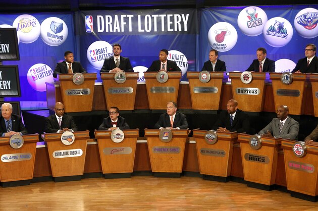 FILE - In this May 21, 2013 file photo, NBA basketball team representatives sit onstage at the start of the NBA draft lottery in New York. The draft lottery is Tuesday, May 20, 2014, a night some teams appeared to be aiming toward for months during a season featuring plenty of talking about tanking. The winner gets the No. 1 pick in next month's draft, when an Andrew Wiggins or Jabari Parker might make all of this season's misery worth it. (AP Photo/Jason DeCrow, File)
