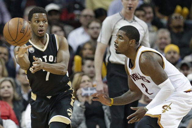 Toronto Raptors' Kyle Lowry (7) passes against Cleveland Cavaliers' Kyrie Irving (2) in the second half of an NBA basketball game Monday, Jan. 4, 2016, in Cleveland. (AP Photo/Tony Dejak)