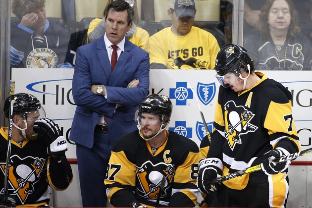 Pittsburgh Penguins' Sidney Crosby (87) and Evgeni Malkin, right, wait on the bench in front of head coach Mike Sullivan during a timeout during the third period of Game 1of the NHL hockey Stanley Cup Eastern Conference finals against the Tampa Bay Lightning, Friday, May 13, 2016 in Pittsburgh. (AP Photo/Gene J. Puskar)
