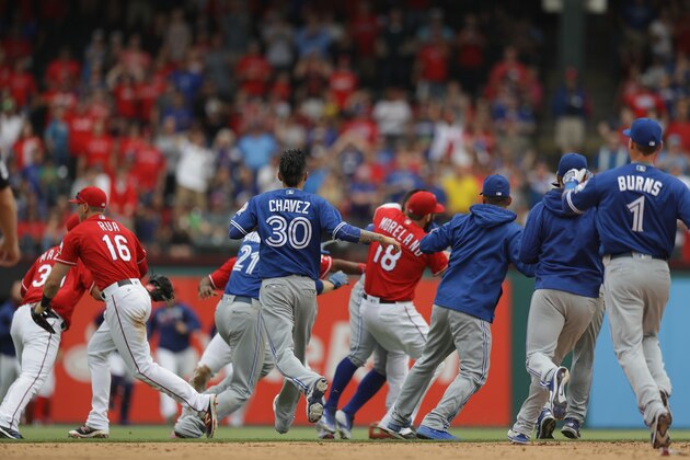 ARLINGTON, TX - MAY 15:  The Toronto Blue Jays and the Texas Rangers clear the bench after Jose Bautista #19 of the Toronto Blue Jays was punched by Rougned Odor #12 of the Texas Rangers in the eighth inning at Globe Life Park in Arlington on May 15, 2016 in Arlington, Texas.  (Photo by Ronald Martinez/Getty Images)