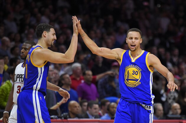 Golden State Warriors guard Stephen Curry, right, celebrates with guard Klay Thompson, center as Los Angeles Clippers guard Chris Paul walks by during the second half of an NBA basketball game, Thursday, Nov. 19, 2015, in Los Angeles.  The Warriors won 124-117. (AP Photo/Mark J. Terrill)