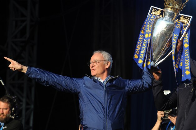 Leicester's manager Claudio Ranieri shows the Premier League Trophy to fans at Victoria Park during the victory parade to celebrate winning the English Premier league title in Leicester, England, Monday, May 16, 2016. (AP Photo/Rui Vieira)