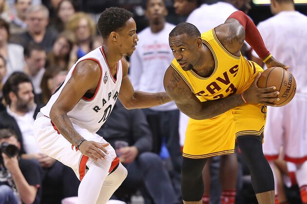 TORONTO, ON - FEBRUARY 26:  LeBron James #23 of the Cleveland Cavaliers keeps the ball away from DeMar DeRozan #10 of the Toronto Raptors during an NBA game at the Air Canada Centre on February 26, 2016 in Toronto, Ontario, Canada. The Raptors defeated the Cavaliers 99-97. NOTE TO USER: user expressly acknowleges and agrees by downloading and/or using this Photograph, user is consenting to the terms and conditions of the Getty Images License Agreement. (Photo by Claus Andersen/Getty Images)