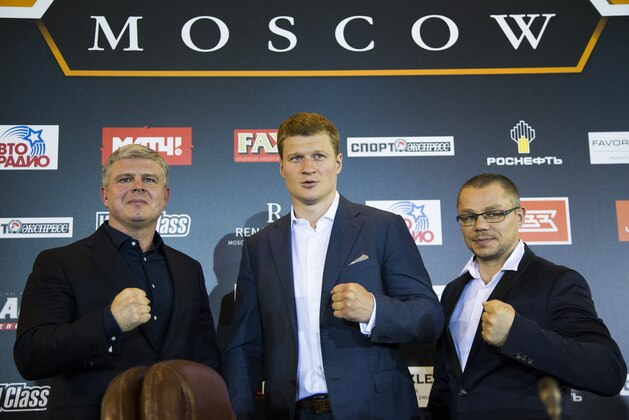Alexander Povetkin of Russia, center, Povetkin's promoter, Andrei Ryabinsky, left, and Povetkin's coach Ivan Kirpa, right, pose for a photo at a news conference in Moscow on Monday, May 16, 2016. Russian heavyweight Alexander Povetkin says he is clean after a failed doping test caused his fight against WBC champion Deontay Wilder to be postponed. Povetkin tested positive for meldonium last month and the WBC ruled Sunday that his bout with Wilder, which had been scheduled for Saturday, May 21 in Moscow, would be delayed for an investigation. (AP Photo/Alexander Zemlianichenko)