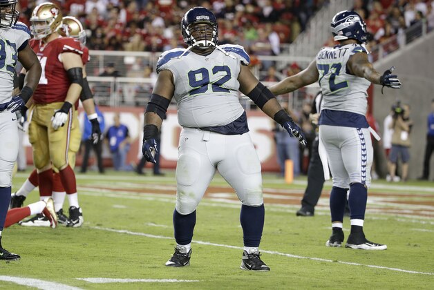 Seattle Seahawks defensive tackle Brandon Mebane (92) and defensive end Michael Bennett (72) react after San Francisco 49ers quarterback Colin Kaepernick was sacked during the second half of an NFL football game in Santa Clara, Calif., Thursday, Oct. 22, 2015. (AP Photo/Marcio Jose Sanchez)