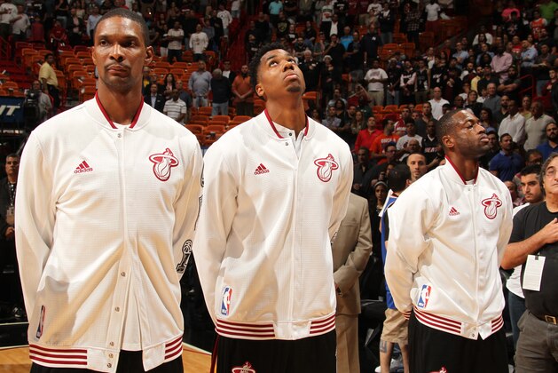 MIAMI, FL - NOVEMBER 23:  Chris Bosh #1 of the Miami Heat, Hassan Whiteside #21 of the Miami Heat and Dwyane Wade #3 of the Miami Heat stand for the national anthem before the game against the New York Knicks on November 23, 2015 at American Airlines Arena in Miami, Florida. NOTE TO USER: User expressly acknowledges and agrees that, by downloading and or using this Photograph, user is consenting to the terms and conditions of the Getty Images License Agreement. Mandatory Copyright Notice: Copyright 2015 NBAE (Photo by Issac Baldizon/NBAE via Getty Images)