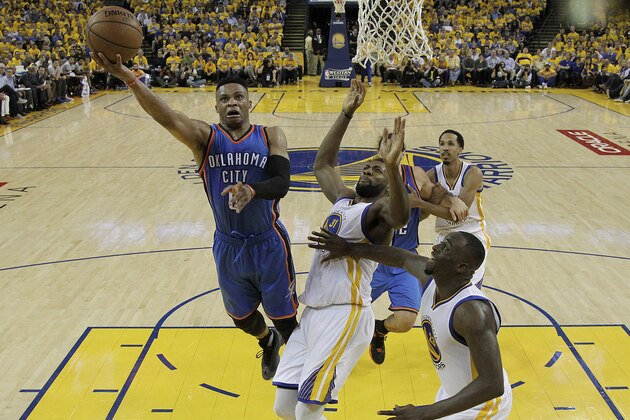 Oklahoma City Thunder guard Russell Westbrook, left, shoots against Golden State Warriors center Festus Ezeli (31) and forward Draymond Green (23) during the second half of Game 1 of the NBA basketball Western Conference finals in Oakland, Calif., Monday, May 16, 2016. The Thunder won 108-102. (AP Photo/Marcio Jose Sanchez) Oklahoma City Thunder guard Russell Westbrook, left, shoots against Golden State Warriors center Festus Ezeli (31) and forward Draymond Green (23) during the second half of Game 1 of the NBA basketball Western Conference finals in Oakland, Calif., Monday, May 16, 2016. The Thunder won 108-102. (AP Photo/Marcio Jose Sanchez)