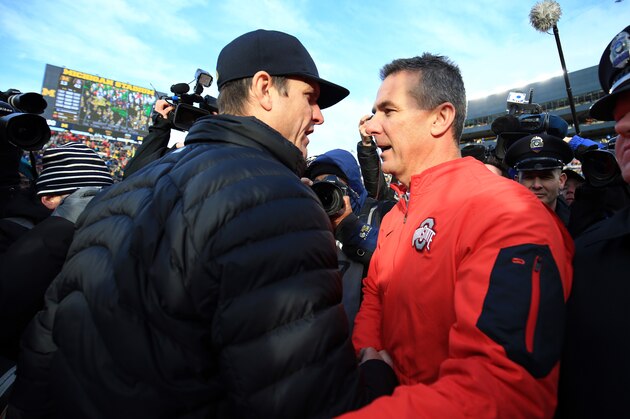 ANN ARBOR, MI - NOVEMBER 28: Head coach Urban Meyer of the Ohio State Buckeyes and head coach Jim Harbaugh of the Michigan Wolverines after the game against the Michigan Wolverines at Michigan Stadium on November 28, 2015 in Ann Arbor, Michigan. Ohio State defeated Michigan 42-13. (Photo by Andrew Weber/Getty Images)