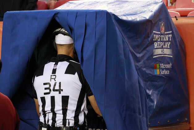 Referee Clete Blakeman (34) uses the instant replay during the first half of an NFL preseason football game between the Denver Broncos and the Arizona Cardinals, Thursday, Sept. 3, 2015, in Denver. (AP Photo/Jack Dempsey)
