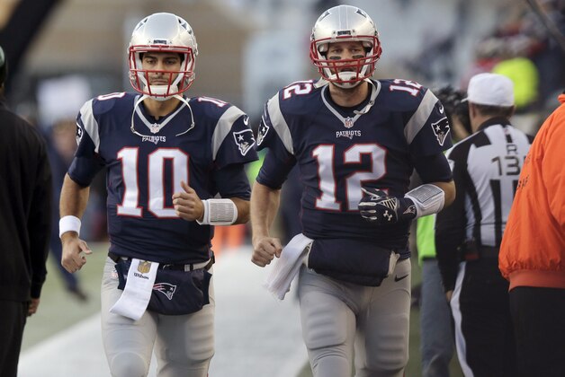 New England Patriots quarterbacks Jimmy Garoppolo, left, and Tom Brady take the field for warm ups before an NFL football game against the Philadelphia Eagles, Sunday, Dec. 6, 2015, in Foxborough, Mass. (AP Photo/Charles Krupa)