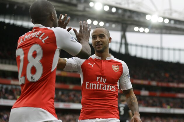 Arsenal's Theo Walcott, right, celebrates scoring his side's fourth goal with Joel Campbell during the English Premier League soccer match between Arsenal and Watford at the Emirates Stadium in London, Saturday, April 2, 2016.  (AP Photo/Matt Dunham)