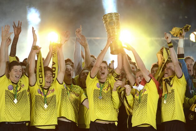 Dortmund's midfielder Sebastian Kehl (C) holds up the trophy and celebrates with teammates after winning the German cup 'DFB Pokal' final football match Borussia Dortmund vs Bayern Munich at the Olympiastadion in Berlin on May 12, 2012. Dortmund defeated Munich 5-2. AFP PHOTO / ODD ANDERSEN        (Photo credit should read ODD ANDERSEN/AFP/GettyImages)