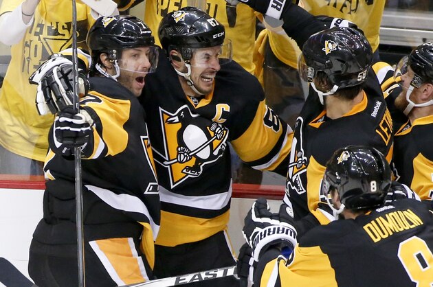 Pittsburgh Penguins' Sidney Crosby, second from left, celebrates with teammates Matt Cullen (7), Brian Dumoulin (8), Kris Letang (58) and Patric Hornqvist. right, after scoring the game winning goal in the overtime period of Game 2 of the NHL hockey Stanley Cup Eastern Conference finals against the Tampa Bay Lightning, Monday, May 16, 2016, in Pittsburgh. The Penguins won 3-2. (AP Photo/Gene J. Puskar)