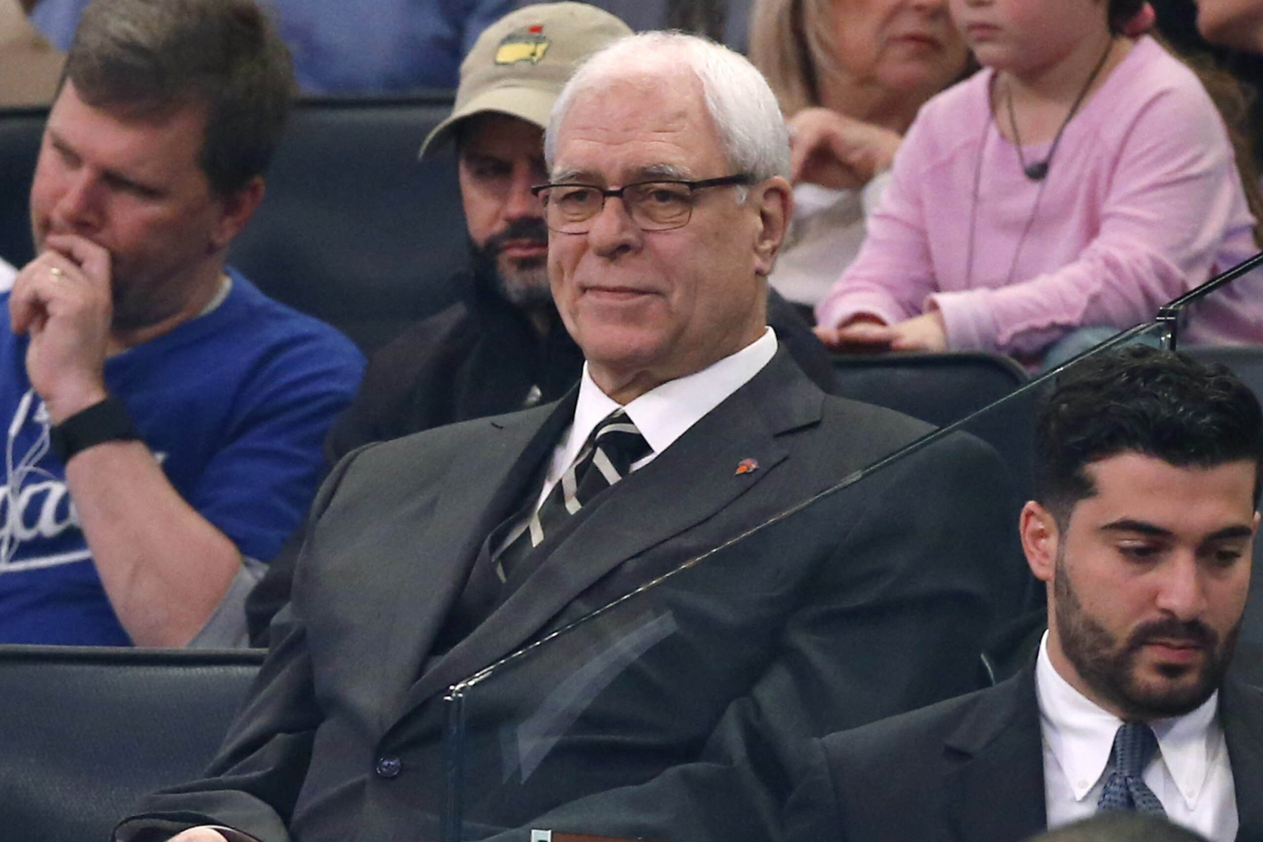 New York Knicks president Phil Jackson, center, watches from the stands in the first half of an NBA basketball game at Madison Square Garden in New York, Sunday, April 10, 2016. (AP Photo/Kathy Willens)