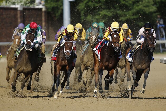 Javier Castellano (12) makes his move on the outside as he rides Cathryn Sophia to victory in the 142nd running of the Kentucky Oaks horse race at Churchill Downs Friday, May 6, 2016, in Louisville, Ky. (AP Photo/Julio Cortez)