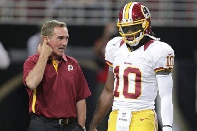 Washington Redskins head coach Mike Shanahan talks with quarterback Robert Griffin III (10) before the start of an NFL football game between the St. Louis Rams and the Washington Redskins Sunday, Sept. 16, 2012, in St. Louis. (AP Photo/Tom Gannam)