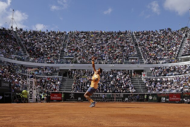 Rafael Nadal of Spain serves the ball to Nick Kyrgios of Australia during their match at the Italian Open tennis tournament, in Rome, Thursday, May 12, 2016. (AP Photo/Andrew Medichini)