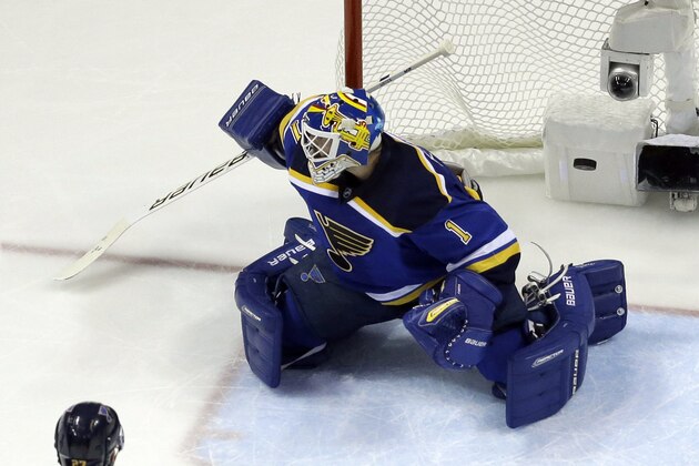 A puck shot by San Jose Sharks defenseman Brent Burns (88) slips past St. Louis Blues goalie Brian Elliott (1) for a goal  during the second period in Game 2 of the NHL hockey Stanley Cup Western Conference finals, Tuesday, May 17, 2016, in St. Louis. (AP Photo/Jeff Roberson)