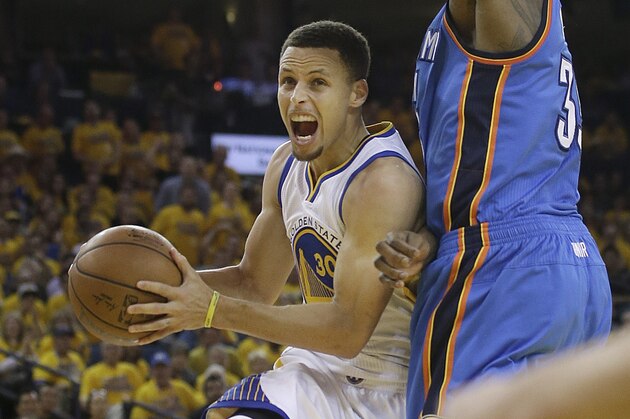 Golden State Warriors guard Stephen Curry, left, shoots against Oklahoma City Thunder forward Kevin Durant during the second half of Game 2 of the NBA basketball Western Conference finals in Oakland, Calif., Wednesday, May 18, 2016. The Warriors won 118-91. (AP Photo/Marcio Jose Sanchez)