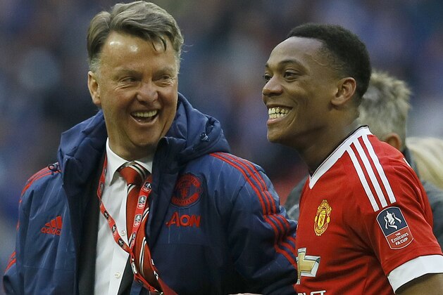 United’s manager Louis van Gaal, left, and United’s Anthony Martial are all smile after winning  the English FA Cup semifinal soccer match between Everton and Manchester United at Wembley stadium in London, Saturday, April 23, 2016.(AP Photo/Kirsty Wigglesworth)
