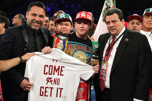 Canelo Alvarez (C) of Mexico celebrates his sixth round knockout of Britain's Amir Khan (out of frame) following their WBC middleweight title fight at T-Mobile Arena on May 7, 2016 in Las Vegas, Nevada.  / AFP / John Gurzinski        (Photo credit should read JOHN GURZINSKI/AFP/Getty Images)