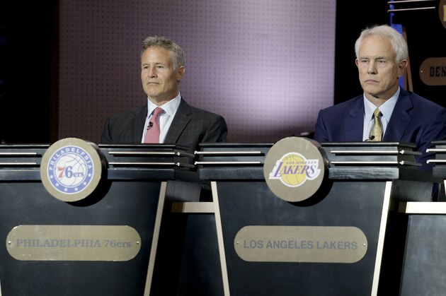 Philadelphia 76ers head coach Brett Brown, left, and Los Angeles Lakers general manager Mitch Kupchak listen as the results of the NBA basketball draft lottery are announced, Tuesday, May 17, 2016, in New York. (AP Photo/Julie Jacobson)