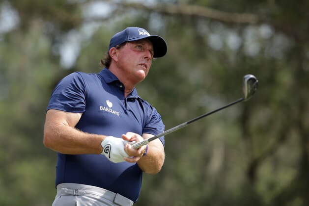 Phil Mickelson follows his shot from the ninth tee during the second round of The Players Championship golf tournament Friday, May 13, 2016, in Ponte Vedra Beach, Fla. (AP Photo/Lynne Sladky)