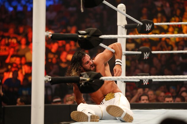 NEW YORK, NY - AUGUST 23: Seth Rollins recovers from a blow during his fight against John Cena at the WWE SummerSlam 2015 at Barclays Center of Brooklyn on August 23, 2015 in New York City.  (Photo by JP Yim/Getty Images)