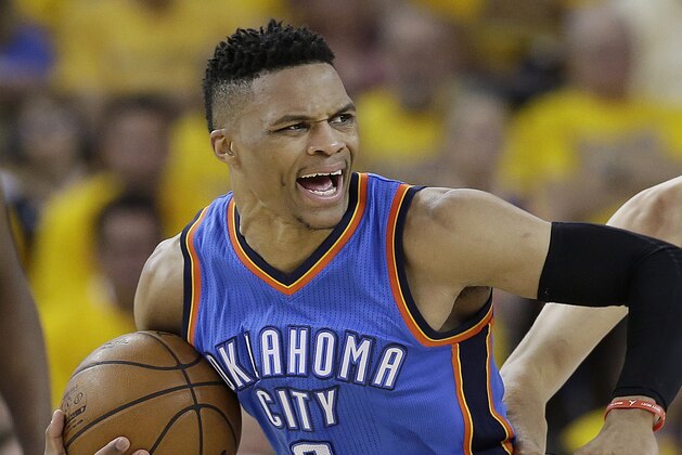 Oklahoma City Thunder guard Russell Westbrook (0) reacts as he is guarded by Golden State Warriors guard Stephen Curry (30) during the second half of Game 2 of the NBA basketball Western Conference finals in Oakland, Calif., Wednesday, May 18, 2016. The Warriors won 118-91. (AP Photo/Marcio Jose Sanchez)