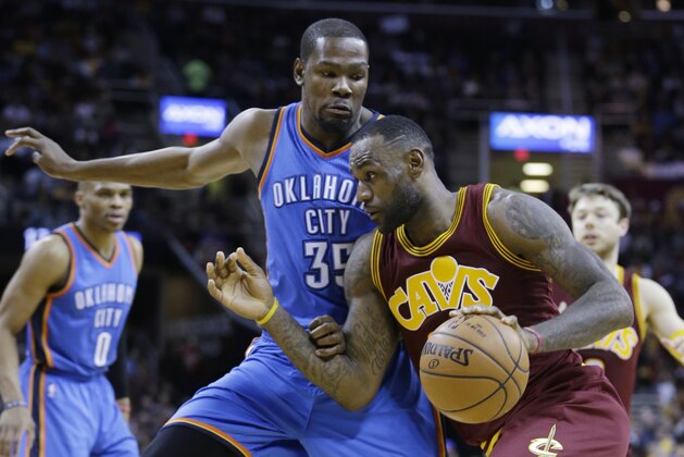Cleveland Cavaliers' LeBron James, front, drives past Oklahoma City Thunder’s Kevin Durant in the second half of an NBA basketball game, Thursday, Dec. 17, 2015, in Cleveland. The Cavaliers won 104-100. (AP Photo/Tony Dejak)